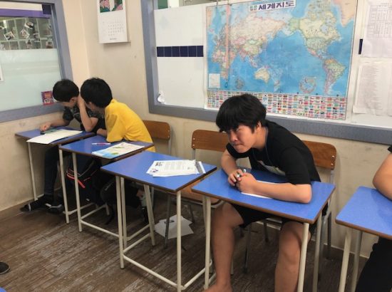 Young people working at desks in a classroom