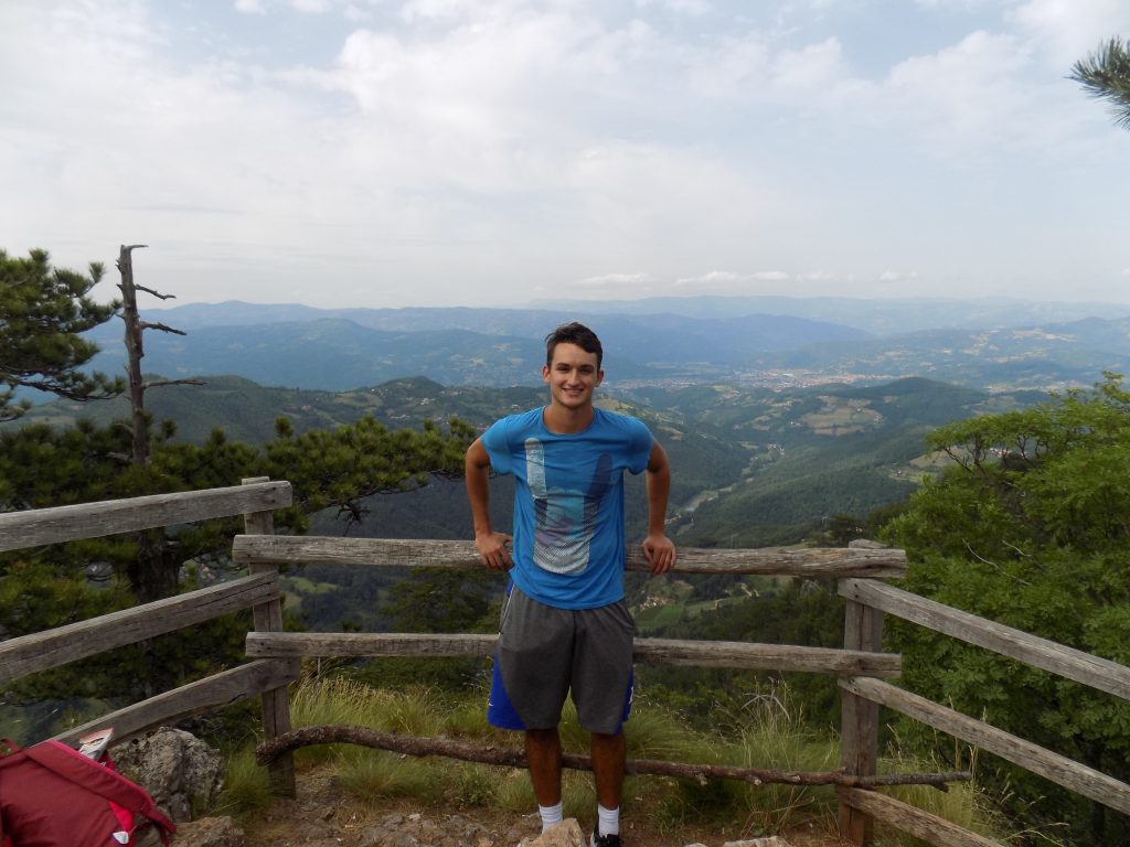 young man posing on scenic overlook