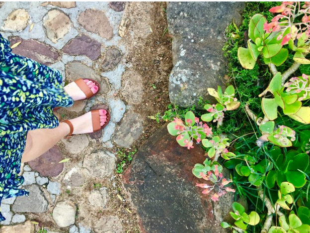 student's feet amid her walk through the gardens