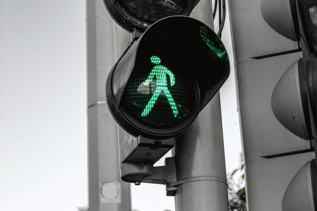 green walk signal at crosswalk