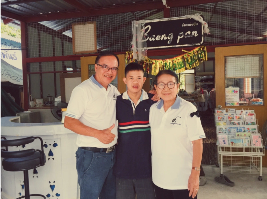 Young man smiling with an older man and woman