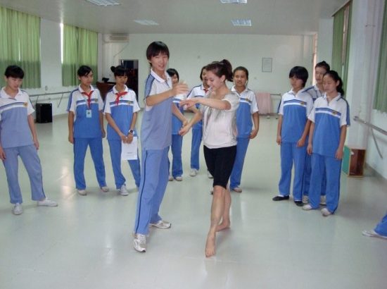 teacher teaching students how to dance