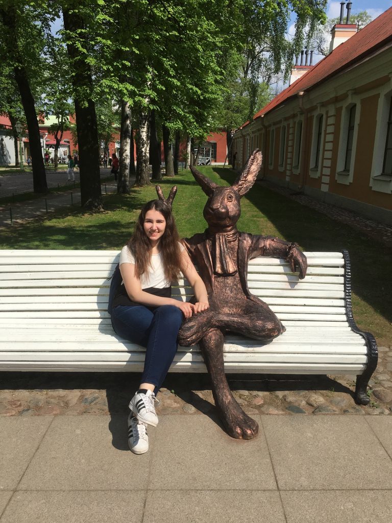 girl posing with statue