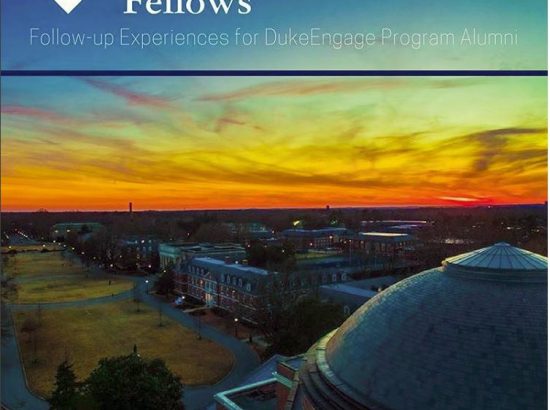 Ariel photo over a domed building with a colorful sunset in the background