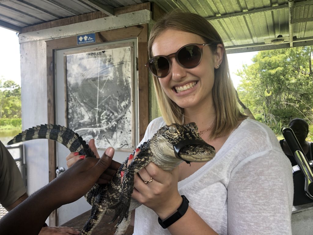 young woman holding small aligator