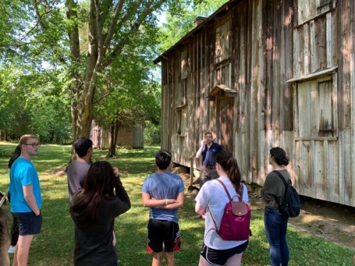 Students outside of the slave quarters