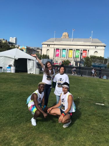 Four students posing at civic center in San Francisco Pride