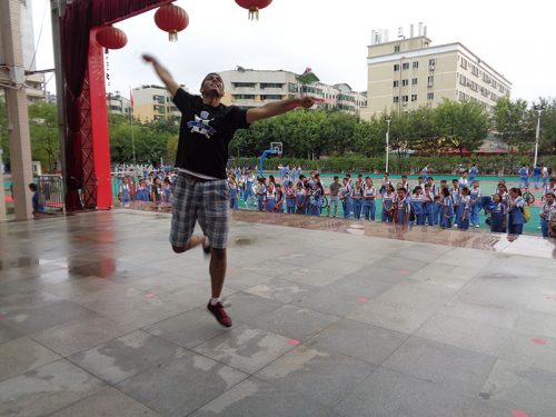 DukeEngage student dancing on stage in front of No 9 students
