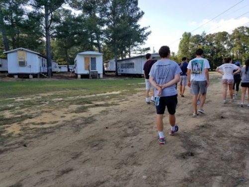 Students walking through farm workers camp.