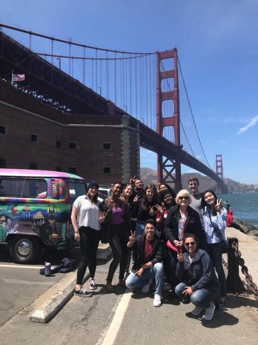 DukeEngage students with VW bus in front of Golden Gate bridge.