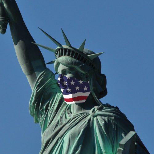 The Statue of Liberty, wearing an American Flag as a facemask.