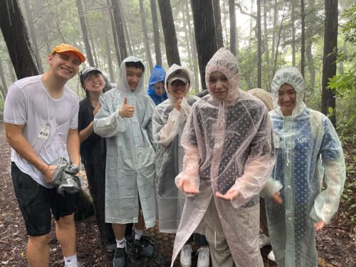 A group of students wearing ponchos in the rain