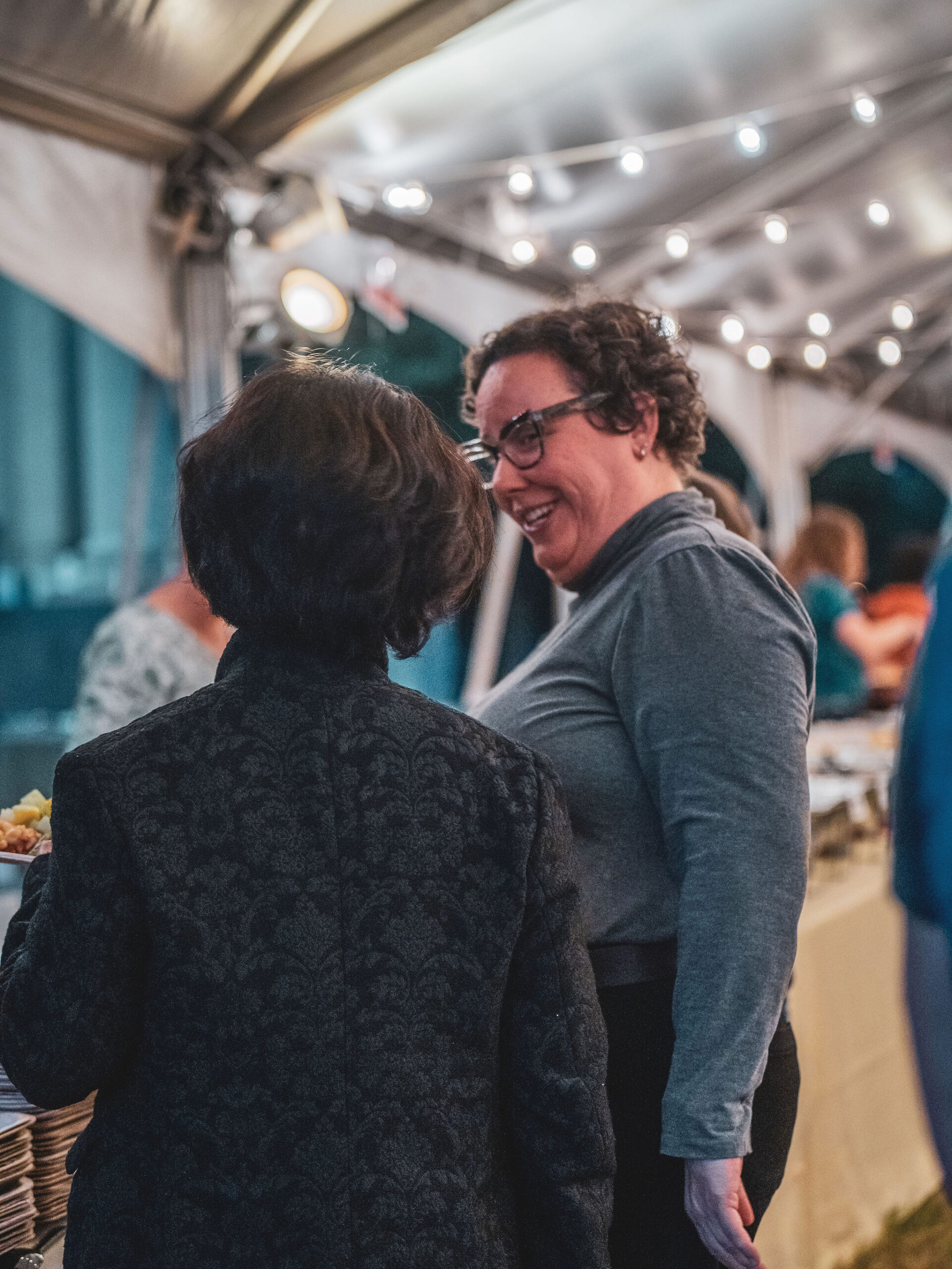 Two standing women speak to each other