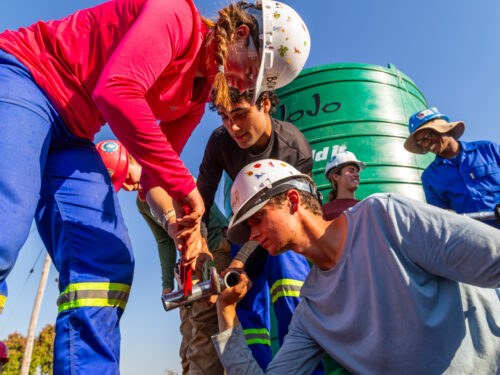 A team of students works on a water line