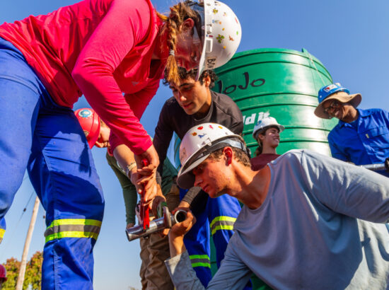 A team of students works on a water line